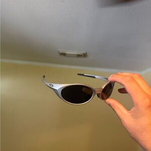 Silver Oval Sunglasses with Black Lenses Oakley Oakleys